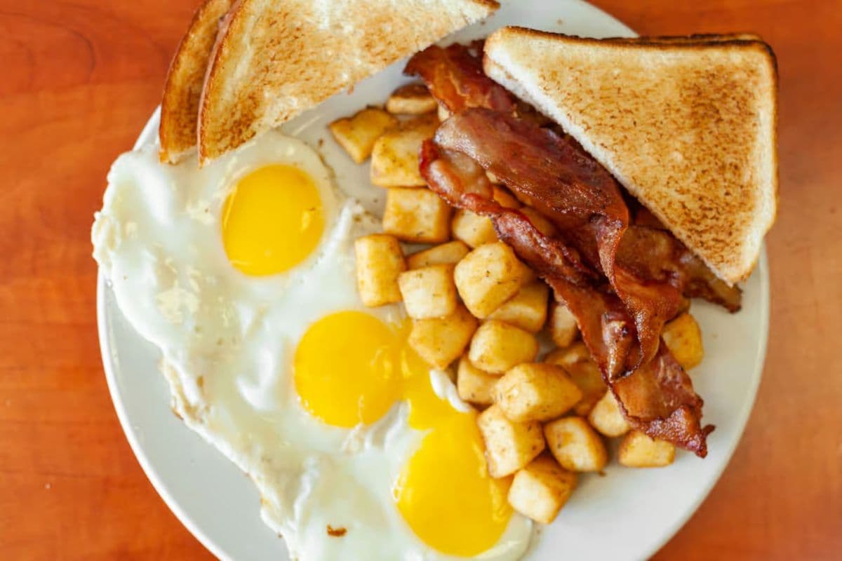 Three Eggs With Hash Brown and Toast