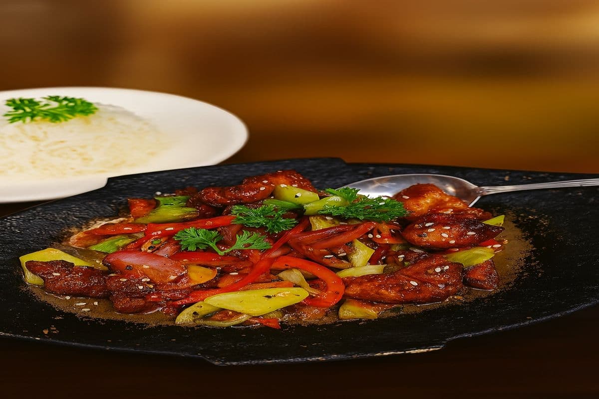 Sweet And Spicy Chili Chicken On A Sizzling Plate