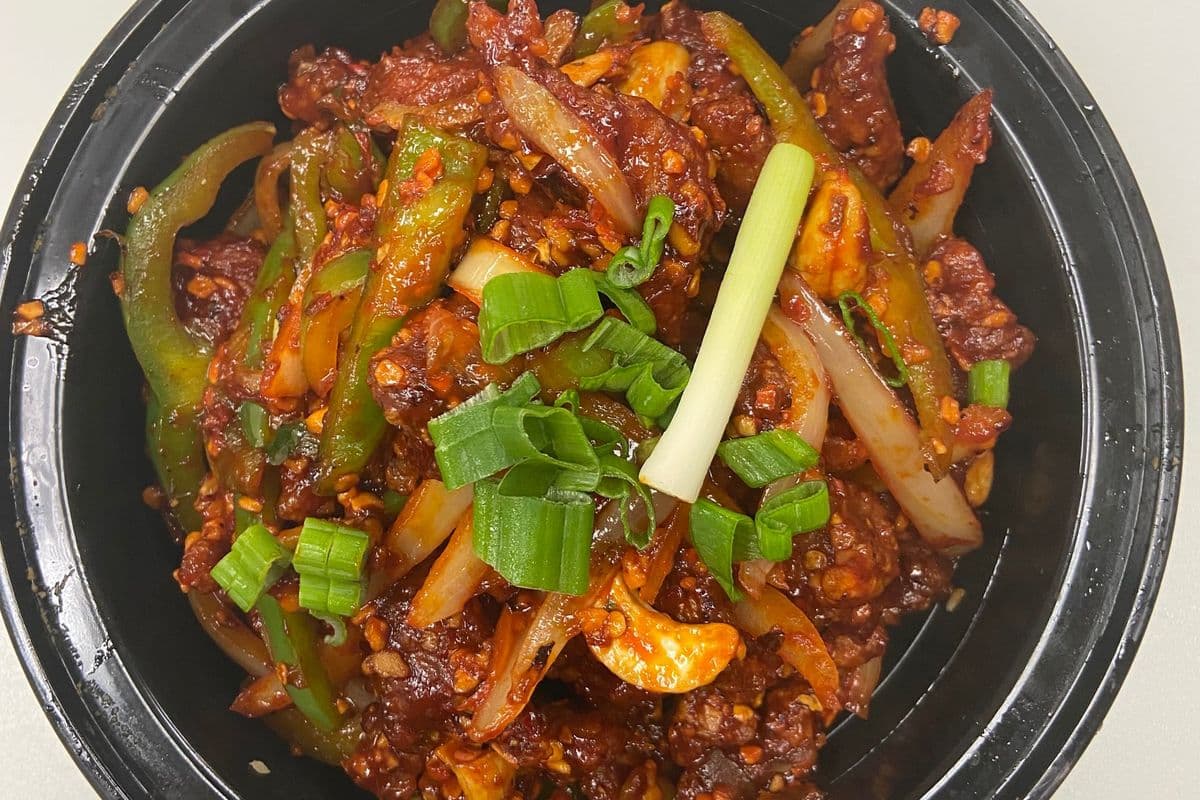 Dragon Beef Dry (Green pepper, onion, chili fried in ginger, garlic, chili flakes , dry garlic, butter and cashew nut and other seasoning)