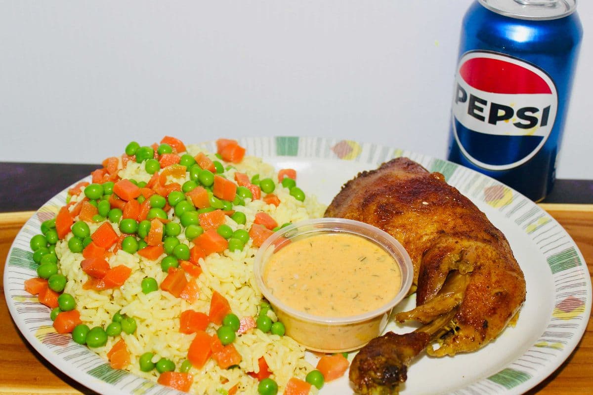 Chicken Leg quarter, Fried Rice, and a can of pop