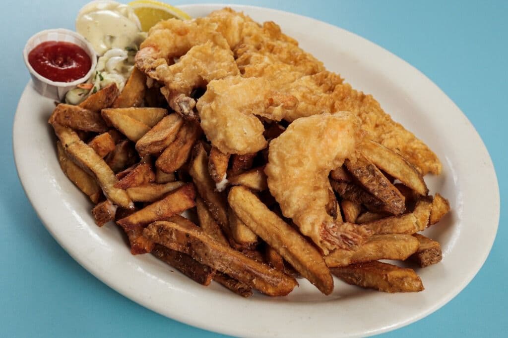 One Piece Haddock, Four Hand Battered Shrimps, Chips, and Coleslaw