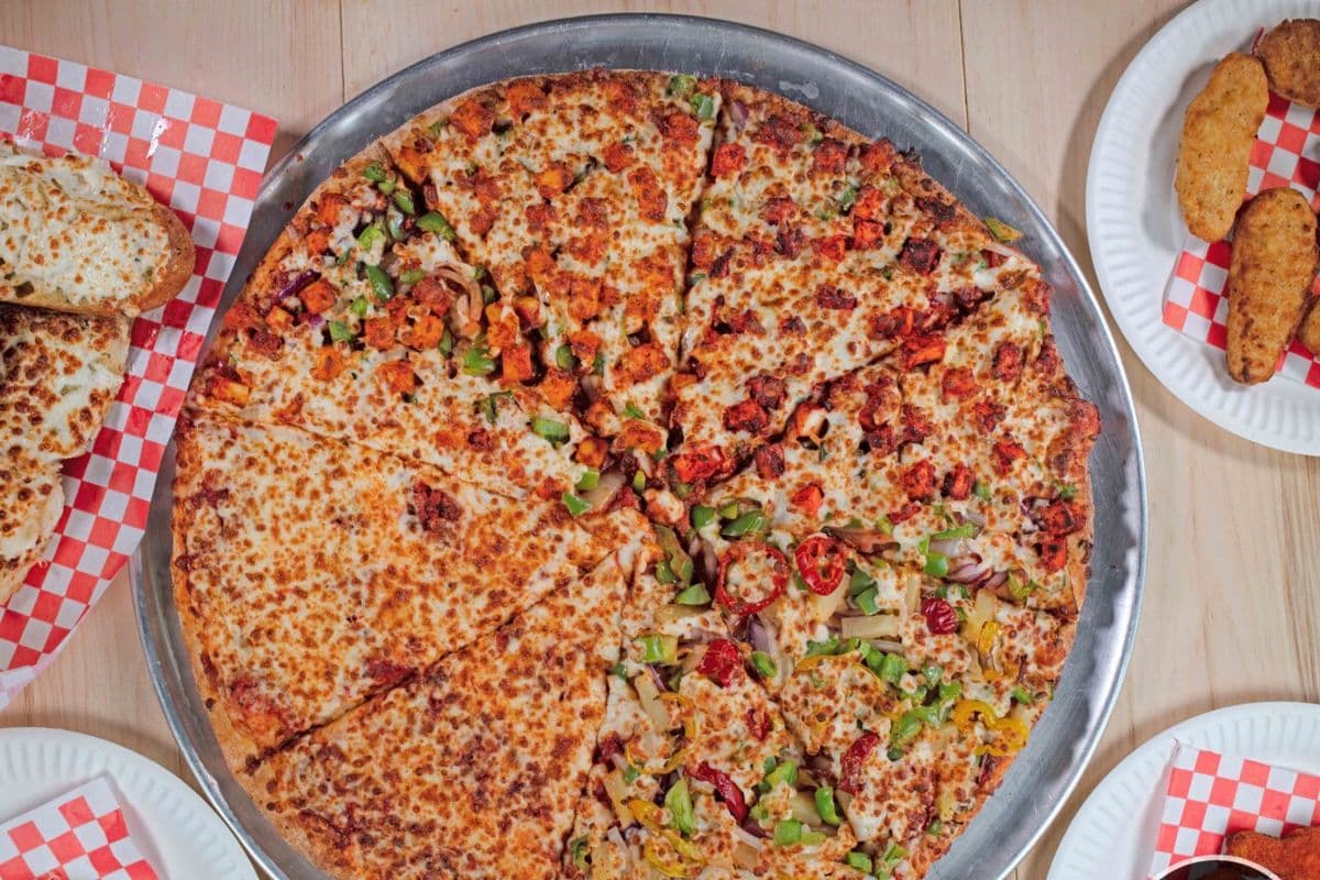 Mr. Singh's Singles (One Medium Pizza, Four Toppings, One Dip, and One Pop)