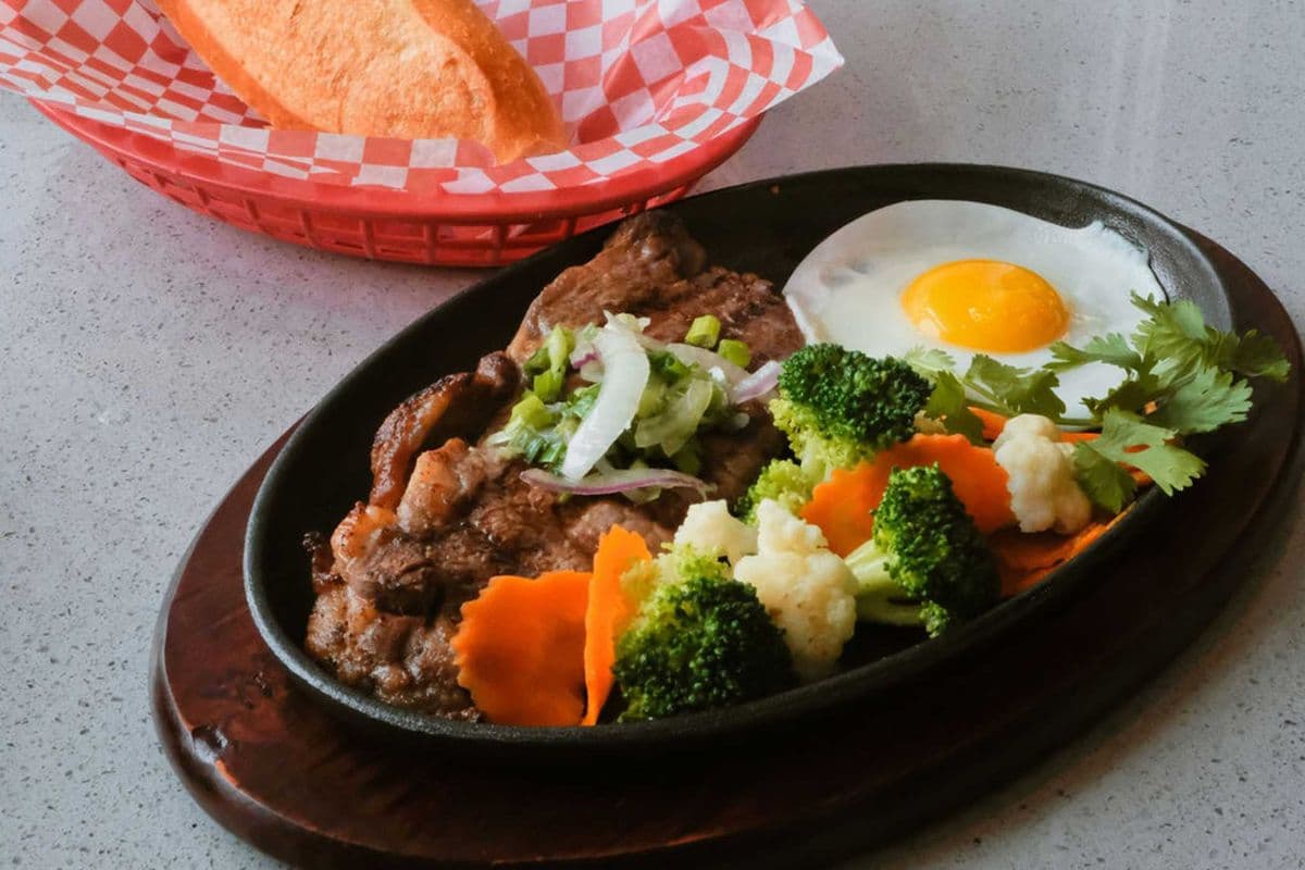 46. Beef Steak, Sunny-Side Egg, and Vegetable on Hot Plate