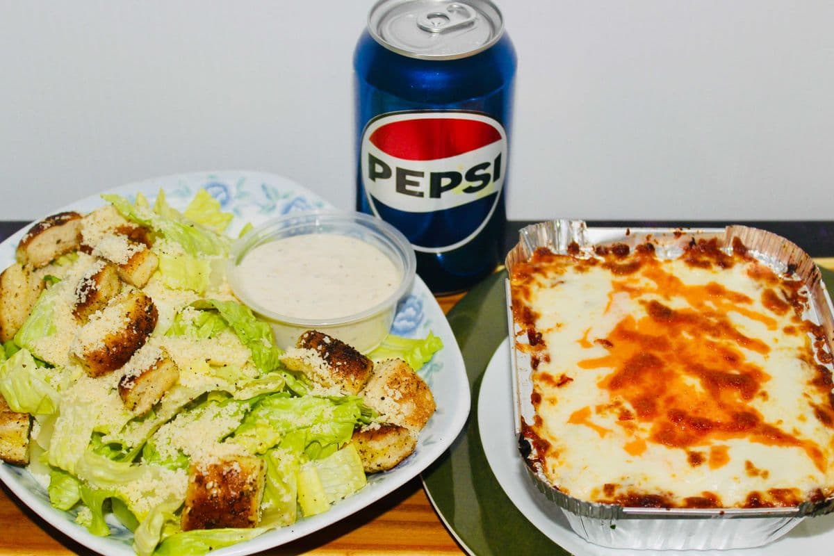 Lasagna(regular size), caesar salad, and a can of pop