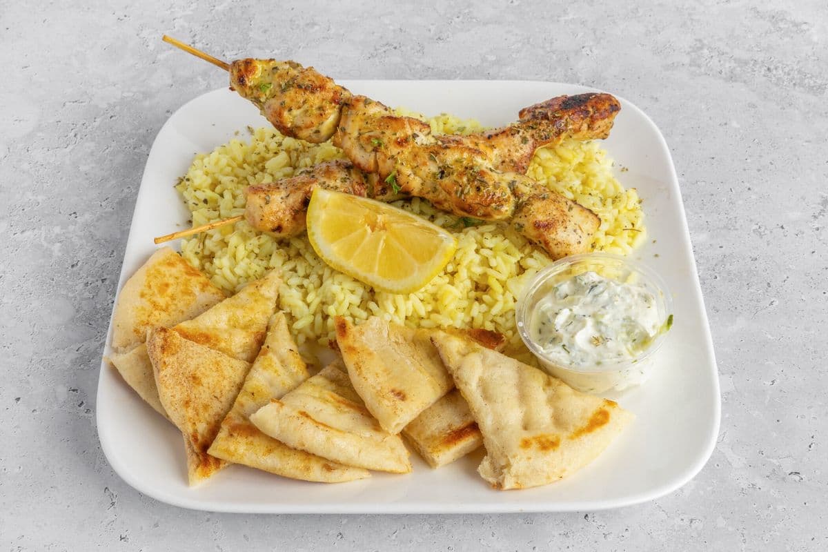 Two Chicken Skewers with Rice, Tzatziki, and Pita Bread