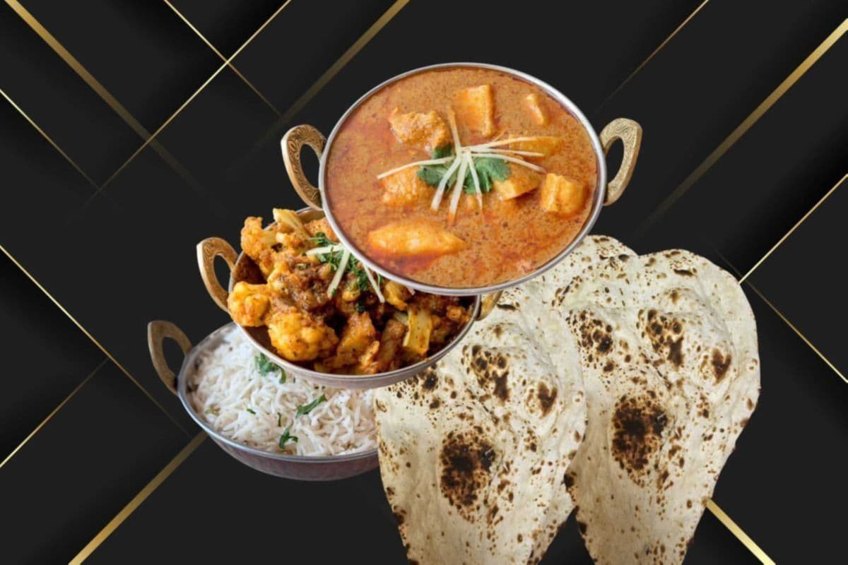 Chicken Curry, Rice, Aloo Gobi, and Three Pieces of Naan