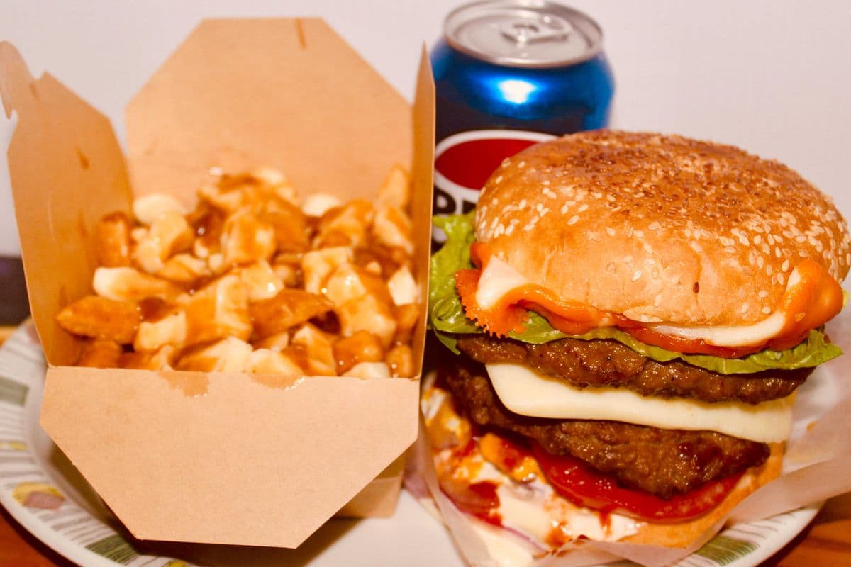 Double patties Cheeseburger, poutine, and a can of pop