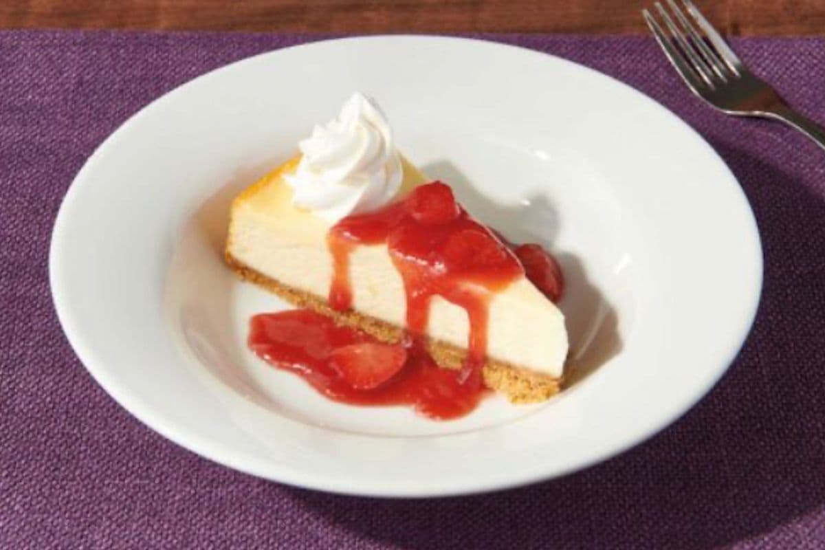 NEW YORK STYLE CHEESECAKE - Topped with strawberry & Whipped Cream (620 Cal)