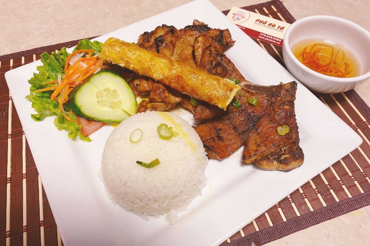96. Steam rice with grilled pork chop, grilled chicken, and spring roll.