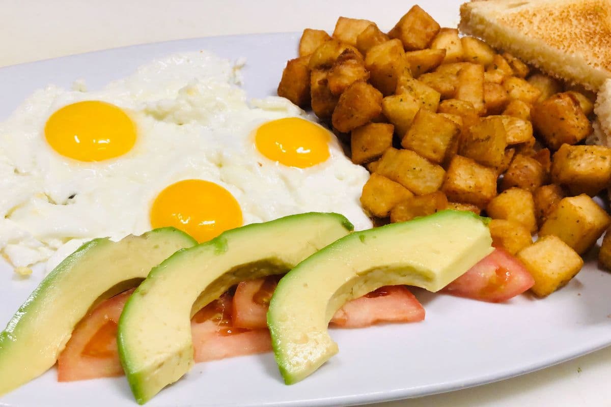 2. Eggs, Tomatoes, Avocado, Toast, and Home Fries