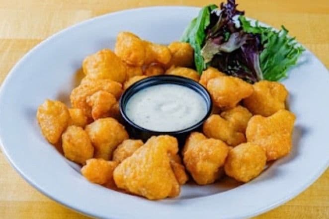 Crispy Cauliflower toasted in buffalo sauce