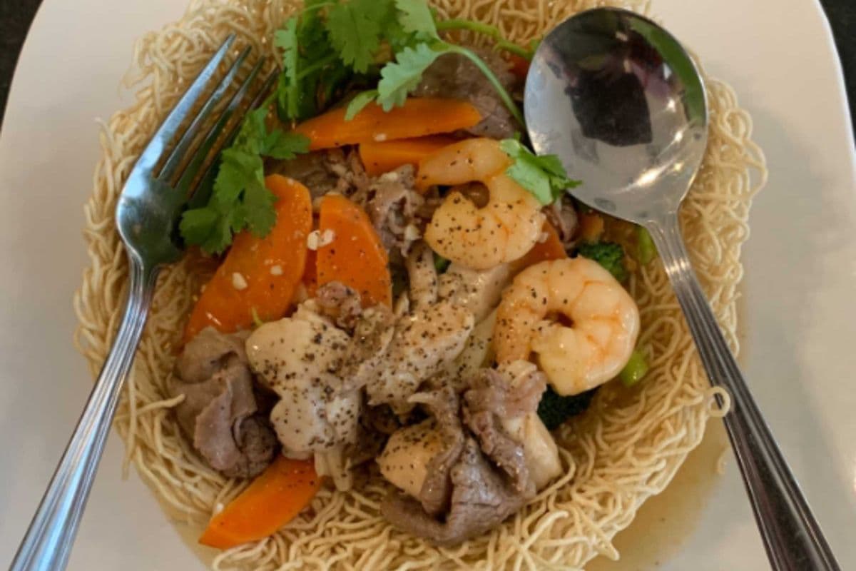 29. Stir-fried shrimp, beef, chicken, and mixed vegetables on Egg Noodles - Mi Xao Don Hoac Mem Thap Cam