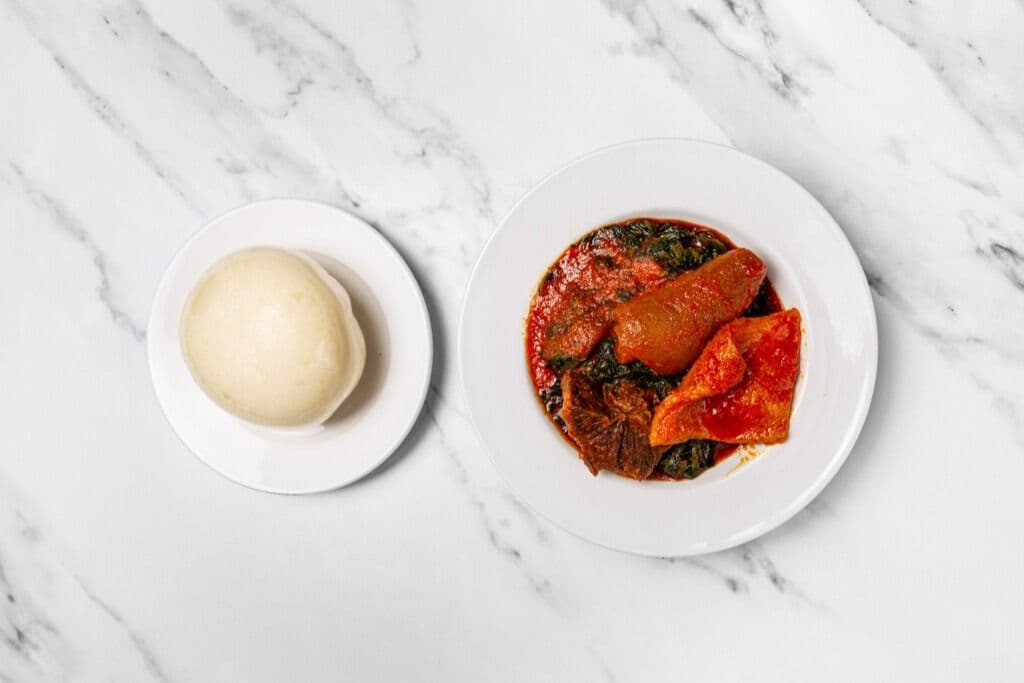 Poundo, Efo Riro Soup (Vegetable Soup), and Two Proteins